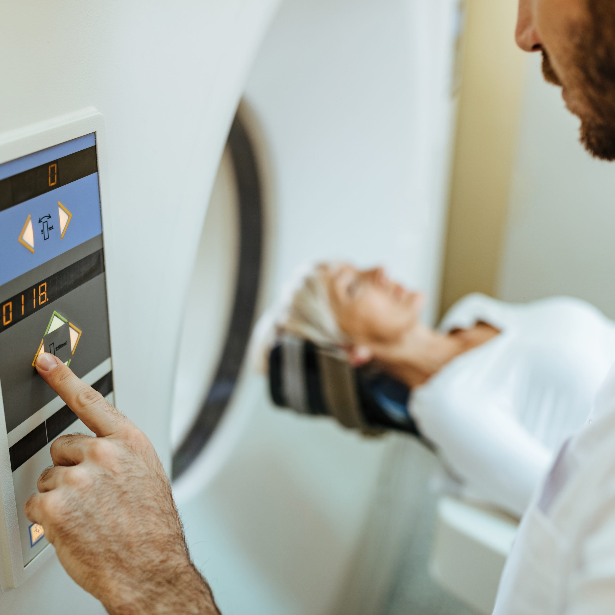 closeup medical technician starting mri scan examination patient in hospital