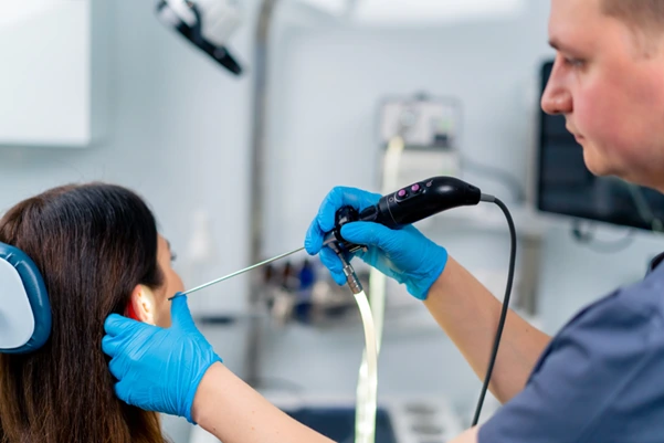 A patient undergoing examination of the ear canal and eardrum procedure