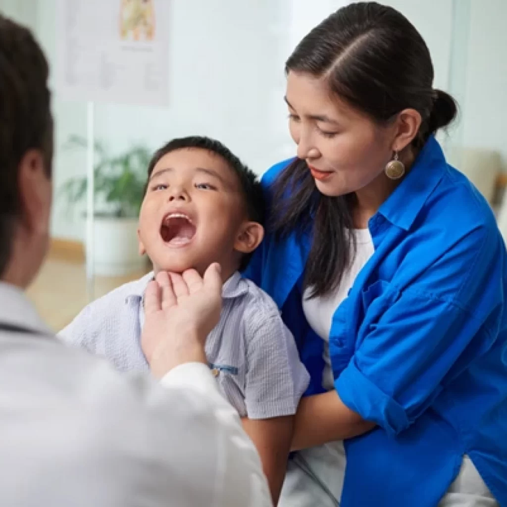 A specialist examining a child’s throat condition