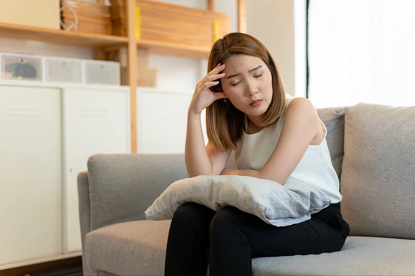 A woman displaying signs of fatigue or distress A woman displaying signs of fatigue or distress