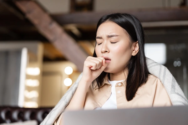 A woman experiencing difficulty breathing through her nose A woman experiencing difficulty breathing through her nose