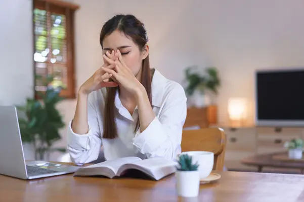 A woman suffering from a sinus headache, a key symptom of chronic sinusitis A woman suffering from a sinus headache, a key symptom of chronic sinusitis