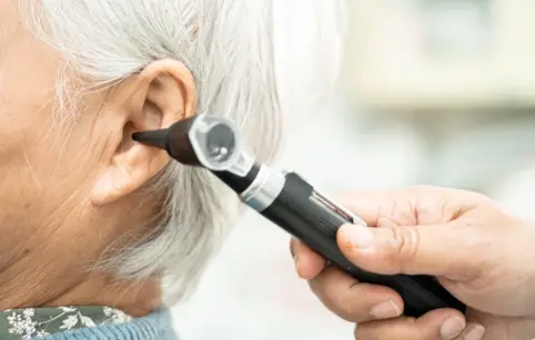 An ear specialist examining the patient’s ear condition An ear specialist examining the patient’s ear condition