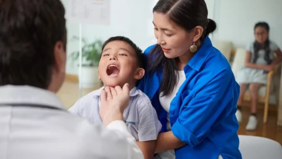 A specialist examining a child’s throat condition