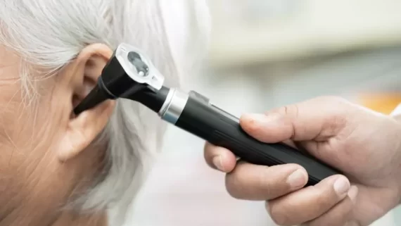 ENT Specialist in Singapore Using Otoscope to Check the Ear of Woman